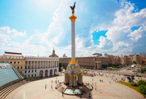 Kiev, Ukraine - May 19, 2013: Maidan Nezalezhnosti (Independence Square) is the central square of Kiev, the capital city of Ukraine. It is located on the Khreshchatyk Street. People in this image are local people of Kiev. The monument in the middle is called Berehynia which is a female spirit in Slavic mythology.